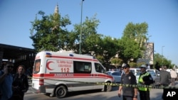 Police officers secure the area after a suicide bomb explosion outside the historical Ulu Cami in Bursa, Turkey, Wednesday, April 27, 2016. 