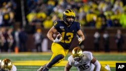 FILE - Michigan running back Tru Wilson rushes 27 yards for a touchdown in an NCAA college football game against Notre Dame in Ann Arbor, Mich., Oct. 26, 2019. 