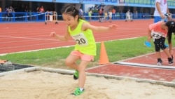 A young athlete jumps during a competition.