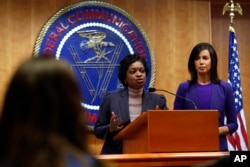 Federal Communications Commission Commissioners Mignon Clyburn, left, and Jessica Rosenworcel answer a question from the media after an FCC meeting to vote on net neutrality regulations, Dec. 14, 2017, in Washington.