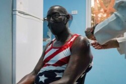 FILE - A man is vaccinated at a vaccination center amid concerns about the spread of the coronavirus disease (COVID-19) in Havana, Cuba, June 17, 2021.