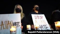 A group of Asian-American women light candles as they attend a peace vigil to mourn the victims of anti-Asian hate crimes at Almansor Park, Alhambra, California, U.S., March 21, 2021. 