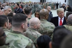FILE - U.S. President Donald Trump and first lady Melania Trump greet U.S. troops at Ramstein Air Force Base, Germany, Dec. 27, 2018.