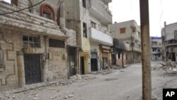 Damaged houses seen at Karm al-Zeitoun near Homs, March 13, 2012. 
