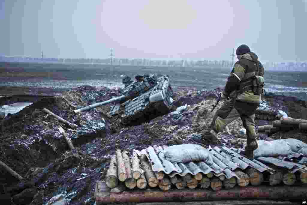 A pro-Russian rebel guards a captured former Ukrainian Army checkpoint outside Vuhlehirsk, Donetsk region, eastern Ukraine, Feb. 5, 2015.