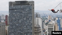 A base jumper leaps from Martinelli building during a competition in Sao Paulo, Brazil, Dec. 4, 2021. 