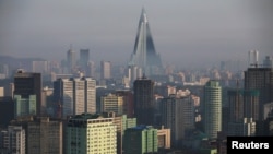 FILE - The 105-story Ryugyong Hotel, the highest building under construction in North Korea, is seen behind residential buildings in Pyongyang, North Korea, May 5, 2016.