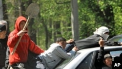 A group of Kyrgyz in the capital, Bishkek. New unrest erupted in Kyrgyzstan as hundreds of rioters armed with sticks and stones clashed with ethnic Russian and Turkish residents in the village of Mayevka, 19 Apr 2010