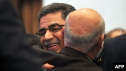 Syrian communications executive Ghassan Hitto (L), is congratulated late on March 18, 2013 in Istanbul after Syria's main opposition National Council elected him as prime minister.
