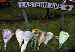 Flowers are placed at the scene where bodies were discovered in a lorry container, in Grays, Essex, Britain, Oct. 24, 2019.