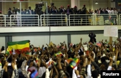 Eritrea's President Isaias Afwerki and Ethiopian Prime Minister Abiy Ahmed look at supporters as they attend a concert at the Millennium Hall in Addis Ababa, Ethiopia, July 15, 2018.