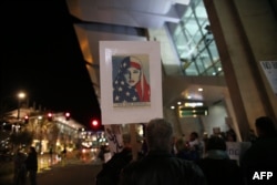 FILE - Protesters chant during a rally against the travel ban at San Diego International Airport in San Diego, March 6, 2017.