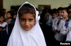 A girl attends morning assembly at the Mashal Model school in Islamabad, Pakistan, Sept. 29, 2017.