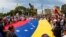 People carry Venezuela's national flag to protest the election results that awarded Venezuela's President Nicolas Maduro with a third term, in Maracaibo, Venezuela, July 30, 2024.