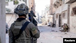 FILE - Israeli soldiers operate in the Gaza Strip on Dec. 14. Israel's Prime Minister Benjamin Netanyahu has said that only the Israel Defense Forces can be trusted to demilitarize Gaza after the war.