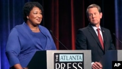 Democratic gubernatorial candidate for Georgia Stacey Abrams, left, speaks as her Republican opponent Secretary of State Brian Kemp looks on during a debate in Atlanta, Oct. 23, 2018.