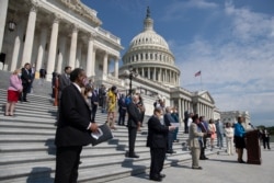 FILE - House Democrats, spaced for social distancing, hold news conference on the House East Front Steps on Capitol Hill in Washington.