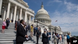 Rep. Karen Bass joined by House Speaker Nancy Pelosi, and other House Democrats spaced for social distancing, speaks during a news conference on the House East Front Steps on Capitol Hill in Washington, June 25, 2020.