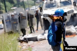 A demonstrator throws a molotov cocktail at security forces during clashes at a rally against Venezuelan President Nicolas Maduro's government in Caracas, Venezuela, July 18, 2017.