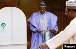 Nigerian President Muhammadu Buhari prepares to cast his vote in Nigeria's election at a polling station in Daura, Katsina State, Nigeria, Feb. 23, 2019.