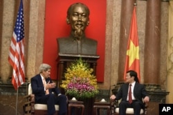 U.S. Secretary of State John Kerry, left, and Vietnamese President Truong Tan Sang talks during a meeting at the Presidential Palace in Hanoi, Vietnam, Friday, Aug. 7, 2015.