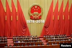 FILE - Chinese President Xi Jinping and others attend an event marking the 40th anniversary of China's reform and opening up at the Great Hall of the People in Beijing, China, Dec. 18, 2018.