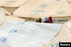 Displaced women, who fled from the Islamic State violence, gather at a refugee camp in the Makhmour area near Mosul, Iraq, June 17, 2016.
