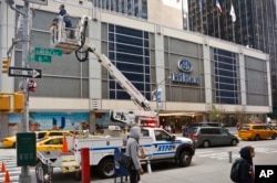 New York City police install security cameras near the Hilton Hotel in New York, Nov. 4, 2016, where Donald Trump organizers will gather on election night. The police and the FBI say they are assessing information they received of a possible al-Qaida attack against the U.S. on the eve of Election Day.
