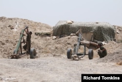 FILE - Fighters of the Syria Democratic Forces prepare to fire a mortar shell toward positions held by Islamic State fighters in northern province of Raqqa, Syria, May 27, 2016.