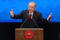 FILE - Turkish President Recep Tayyip Erdogan delivers a speech at the Bestepe National Congress and Culture Center in Ankara, July 21, 2020.