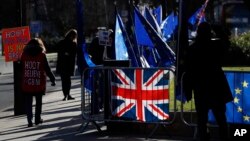 Pro and Anti Brexit protesters demonstrate outside the Houses of Parliament in London, Jan. 28, 2019.