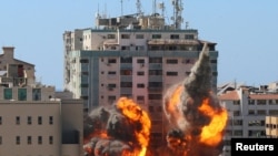 The al-Jalaa building housing Associated Press (AP) and Al Jazeera media offices is hit by an Israeli air strike in Gaza City, May 15, 2021. 