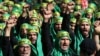 Lebanese Shi'ite supporters of the Iranian-backed Hezbollah group, shout slogans as they march marking the Ashoura holiday, in a southern suburb of Beirut, Lebanon, Oct. 12, 2016. Hezbollah – known as “the Party of God” – is considered a terrorist organization by the U.S. and European allies, and follows a Shi'ite ideology that calls for the destruction of Israel. 