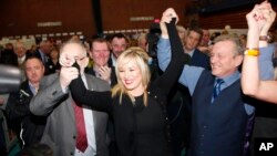 Sinn Fein's party leader for Northern Ireland Michelle O'Neill celebrates with party members Francie Molloy (left) and Ian Milne (right) after topping the poll in Mid Ulster, Ballymena count centre, Northern Ireland, March 3, 2017.
