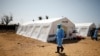 Medical staff wear protective masks at a cholera treatment center set up in the aftermath of Cyclone Idai in Beira, Mozambique, March 29, 2019. 
