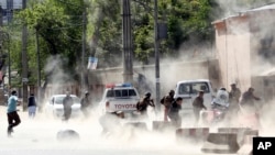 Security forces run from the site of a suicide attack after the second bombing in Kabul, Afghanistan, Monday, April 30, 2018.