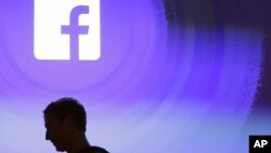 FILE - Facebook CEO Mark Zuckerberg walks at the company's headquarters in Menlo Park, California, April 4, 2013. 