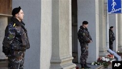 Special force officers guard an entrance to Minsk subway, after identifing suspects in Monday's bombing as the death toll rose to 12, with more than 200 wounded, April 12, 2011.
