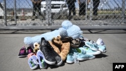 Shoes are left by people at the Tornillo Port of Entry near El Paso, Texas during a protest rally by several American mayors against the US administration's family separation policy.