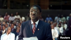 FILE - A photo from 2003 shows then-Kenyan Attorney General Amos Wako addressing a judicial commission.