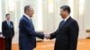 In this photo released by the Russian Foreign Ministry Press Service on April 9, 2024, Russian Foreign Minister Sergey Lavrov and Chinese President Xi Jinping shake hands during their meeting in Beijing, China.