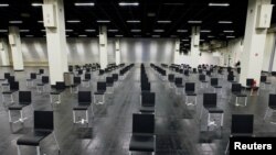 Empty chairs are seen at a makeshift COVID-19 vaccination site in Cologne, Germany, March 18, 2021.