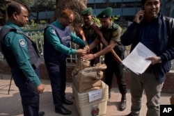 Bangladeshi police seal the voting material at a distribution center before being transported to polling stations on the eve of the general elections in Dhaka, Bangladesh, Dec. 29, 2018.