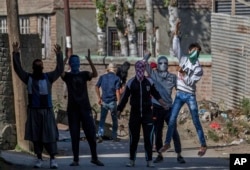 FILE - Masked Kashmiri protesters shout pro-freedom slogans during a protest in Srinagar, Indian-controlled Kashmir, Oct. 14, 2016.