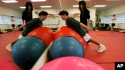 YMCA of Burlington County Wellness Director Joann Agoglia stands by as cancer survivor Clare Faber, of Mount. Holly, N.J. works through an exercise program, Aug.11, 2009, in Mount Laurel, N.J. 