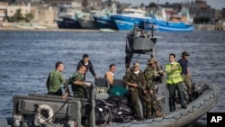 An Egyptian coast guard dinghy brings bodies from a Europe-bound boat that capsized off Egypt’s Mediterranean coast, to the shore in Rosetta, Egypt, Sept. 22, 2016.