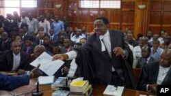 Opposition lawyer and party official James Orengo hands a letter informing him that his own passport has been suspended by the government, to the judge in the case of opposition politician Miguna Miguna, at the High Court in downtown Nairobi, Kenya, Feb. 