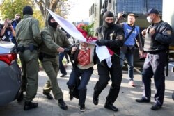 Police officers detain Nina Baginskaya, 73, during an opposition rally challenging official presidential election results in Minsk, Belarus, Sept. 19, 2020.