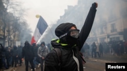 A protestor gestures during a demonstration against French government's pensions reform plans, as part of a day of national strike and protests, in Paris, France, December 5, 2019. REUTERS