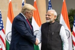 FILE - President Donald Trump and Indian Prime Minister Narendra Modi shake hands before their meeting at Hyderabad House, in New Delhi, India, Feb. 25, 2020.